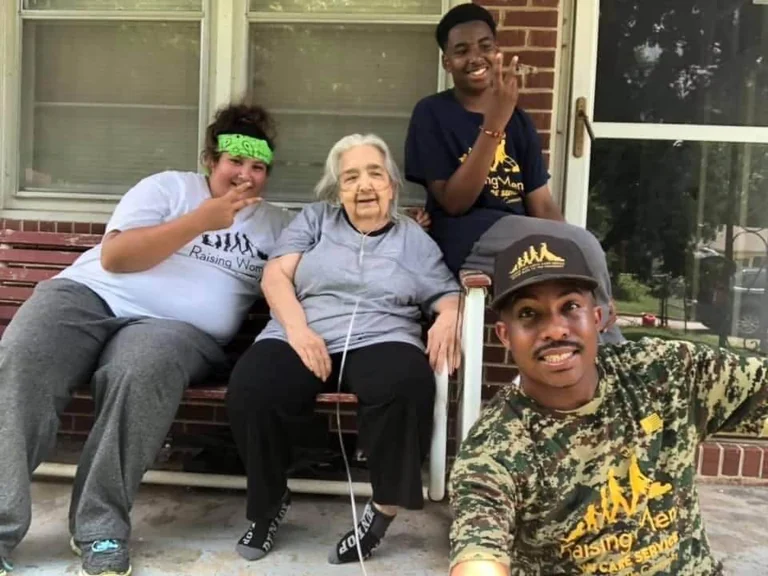 Miss Mary Gibbs pictured on her porch with Rodney and young volunteers