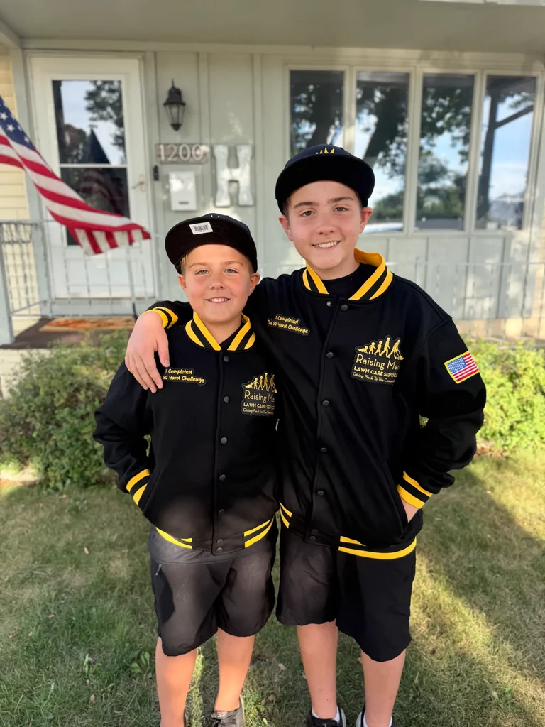 Two young participants wearing black 50 Yard Challenge jackets