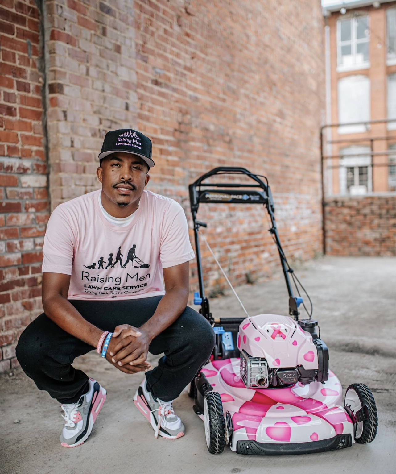 Rodney Smith Jr. with the breast cancer awareness lawnmower
